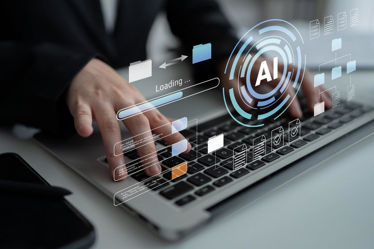 Person typing at a laptop with a holographic AI interface floating above the keyboard, showing document and workflow icons.