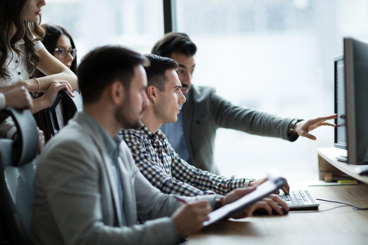 Businessmen looking at computer