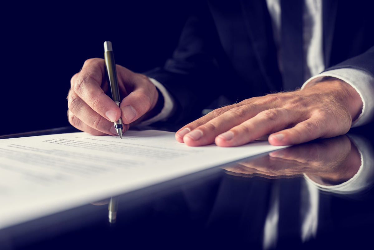 A businessman writing on a piece of paper