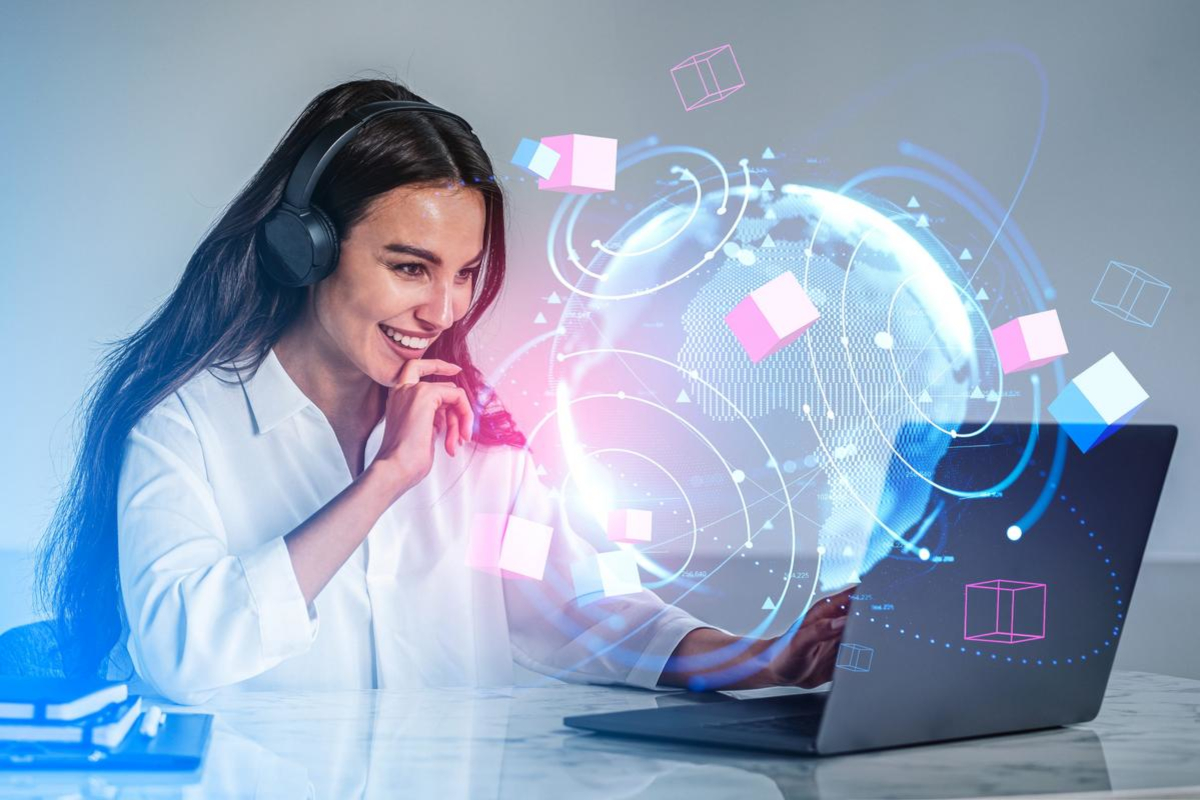 Smiling woman working on laptop.