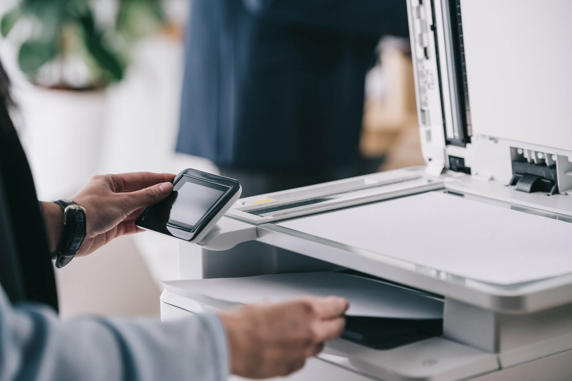 Close up shot of a person using a modern copier